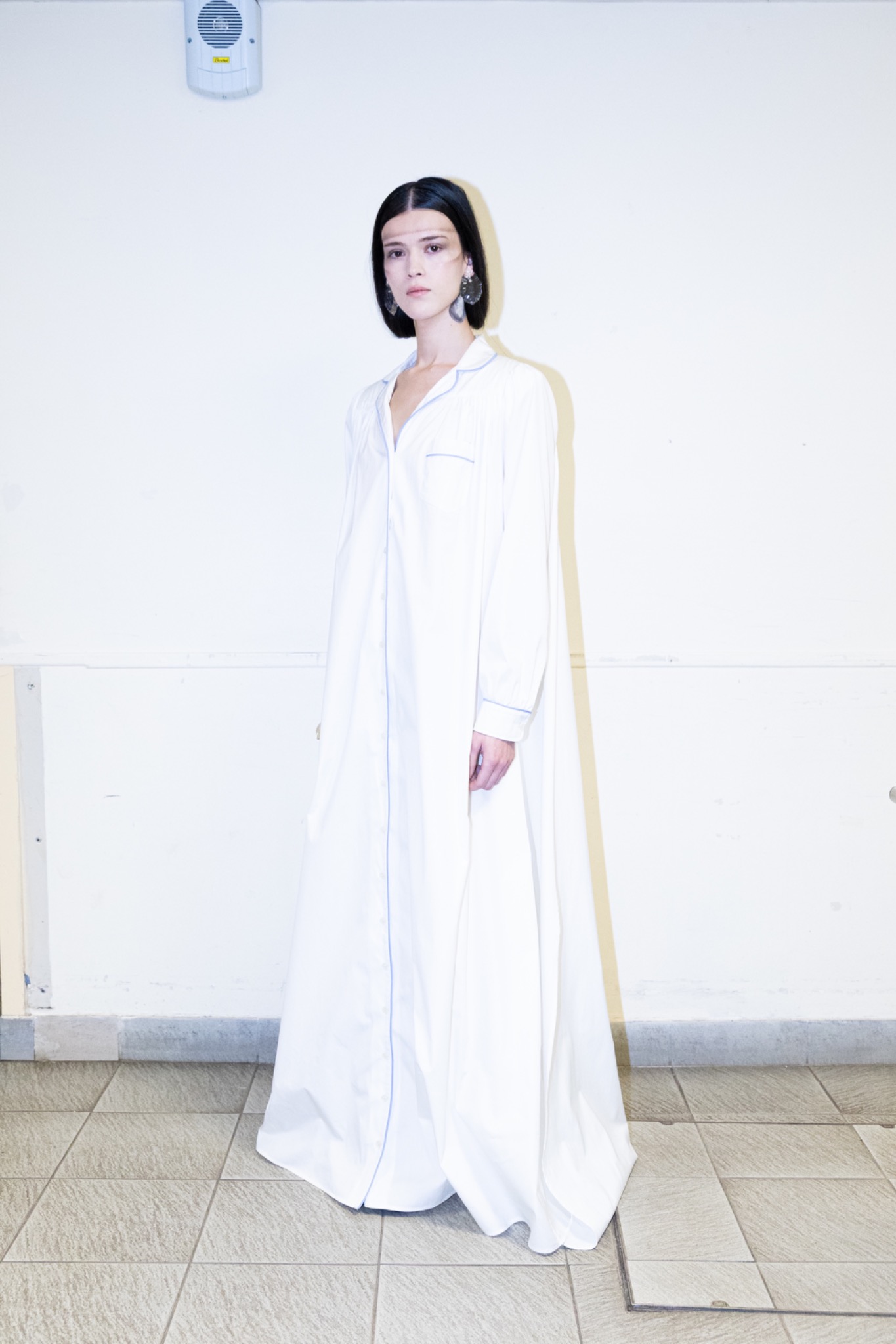 Silhouette de mode en robe blanche en coulisses